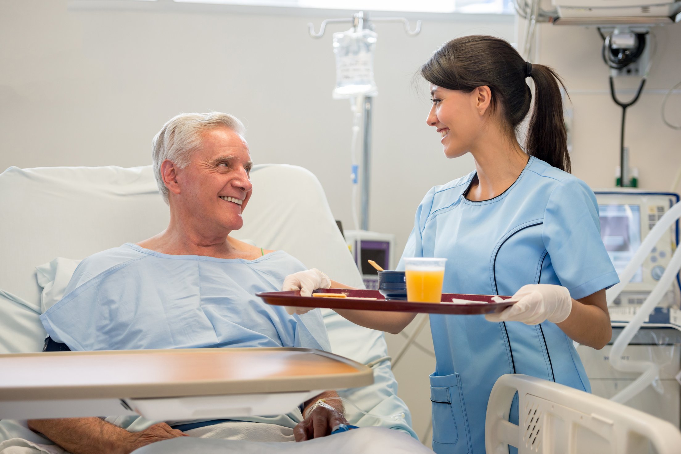 Nurse serving food to patient in the hospital